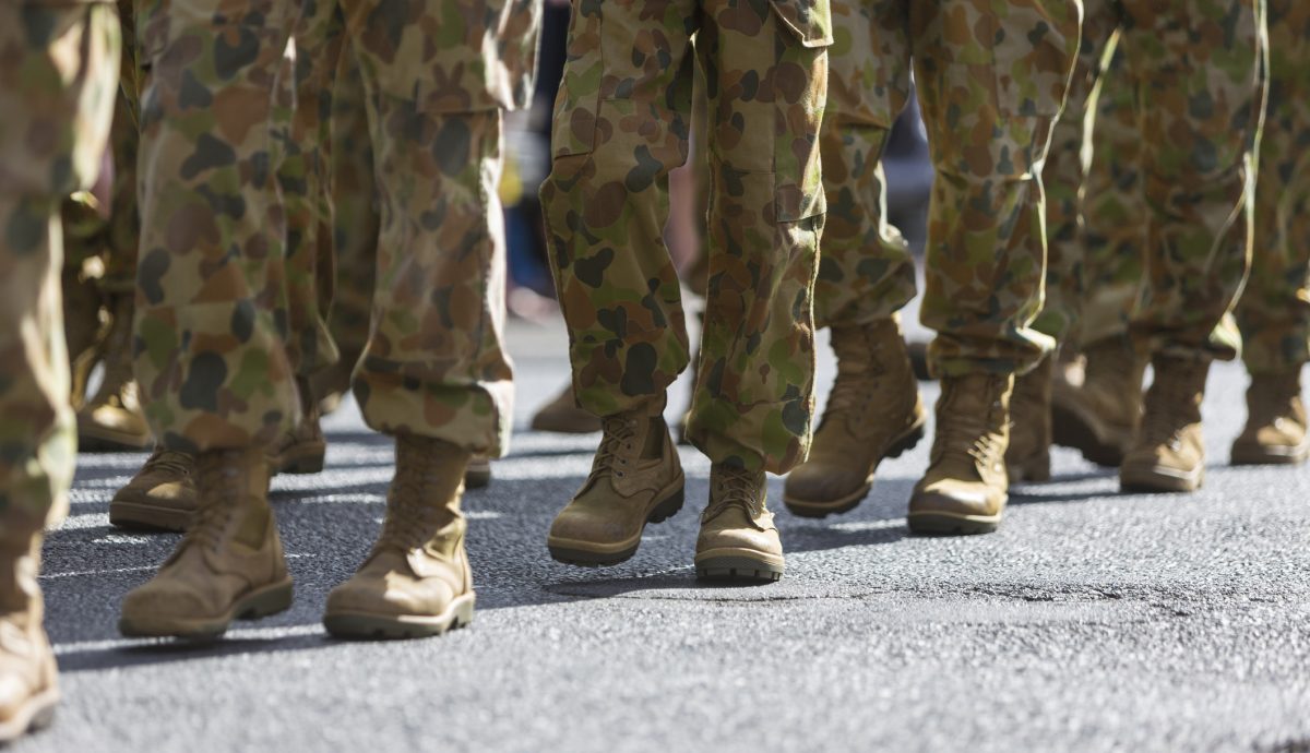 Feet of soldiers marching at an ANZAC Day parade on the streets of a regional country town