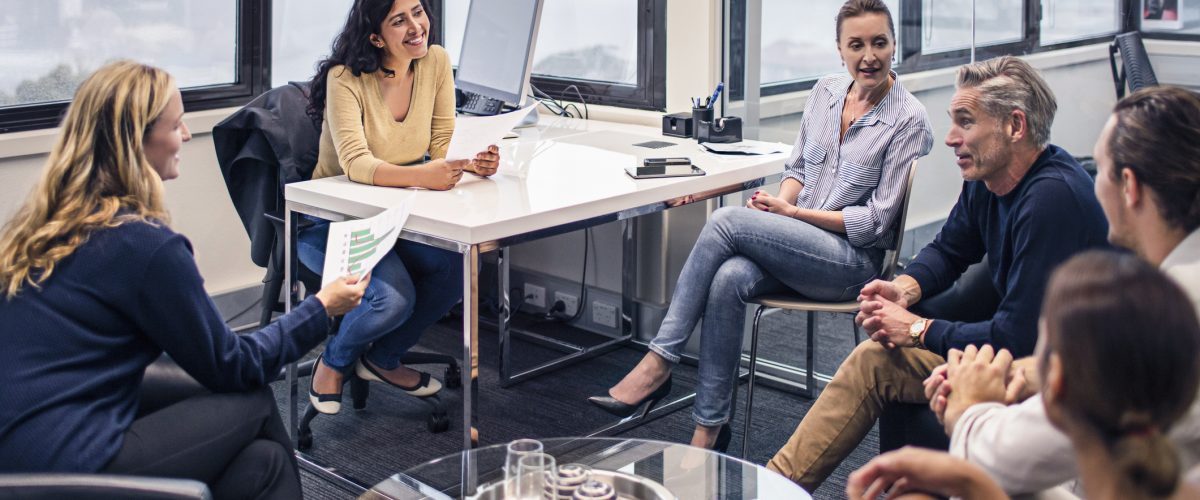 Business people on a meeting in the office with Sydney Harbour bridge in the background.